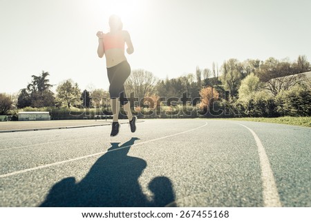 runner on the track. woman making speed training
