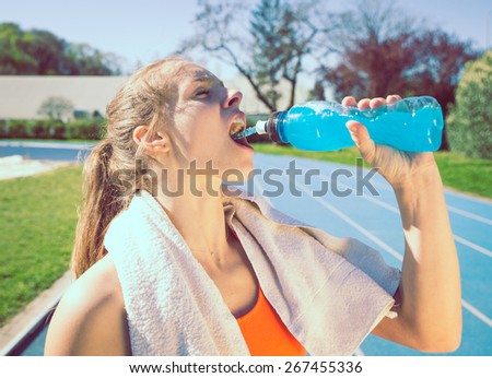 woman drinking power drinking after long run. concept about sport