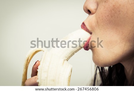 woman eating banana. close up on banana and mouth