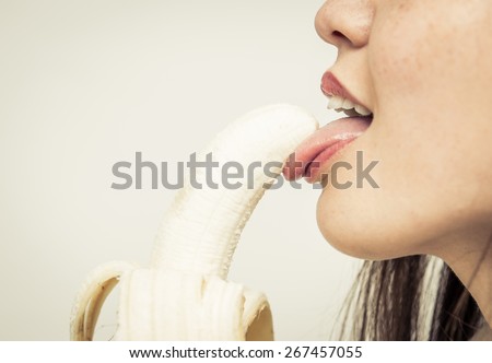woman eating banana. concept about food and people
