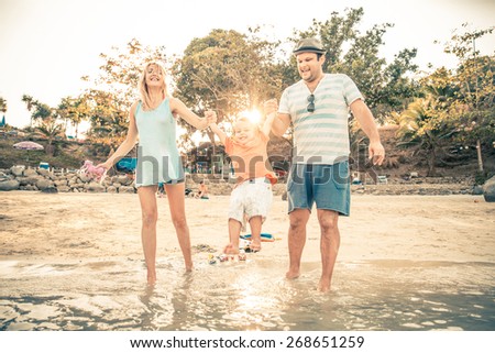 Mom and dad playing with their handsome son - Family and baby outdoors