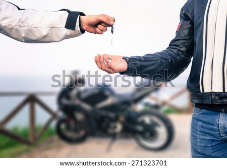 key exchange. Motorcycle concept. friends exchanging the bike key.