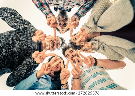 Multiracial group of people in circle making a star shape with hands gesture - Friends looking down with v-shapes finger position - Concepts about friendship,lifestyle,unity,business and teamwork