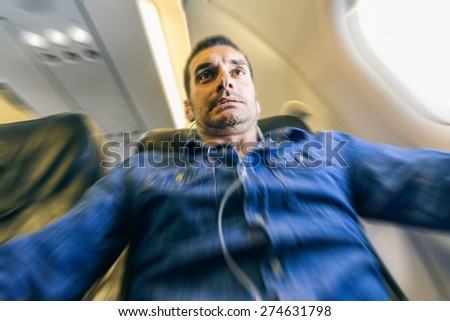 Airplane passenger in shock while the plane is in a turbolence area