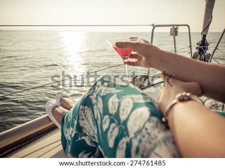 woman drinking cocktail on the boat. concept about leisure, summer, vacations and people