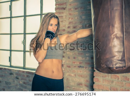 fighter training. woman punching the boxing heavy bag . concept about sport, fighting and sport