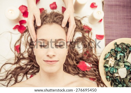head massage. young woman making massage in the spa. concept about beauty, spa, and massages