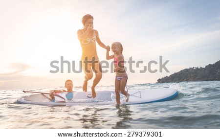 happy family diving in the water. Mom and daughter jumping from the surf.concept about vacation, family and people