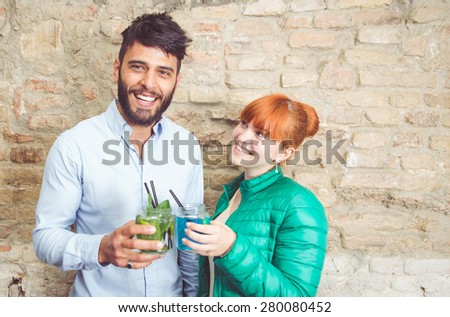 couple making toast with cocktails. concept about couples, fun and people