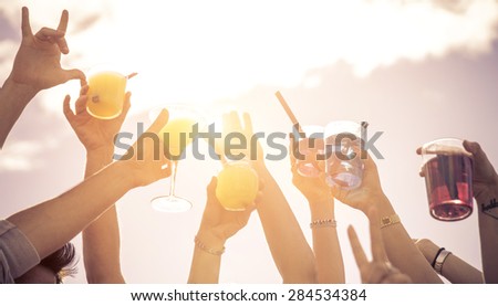 hands up to the sky with cocktails. people at music festival making party