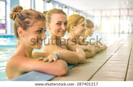group of girls relaxing in the spa swimming pool. concept about beauty,leisure and people
