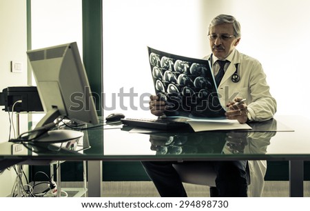 doctor checking the x-ray test in his office. concept about health care and medicine