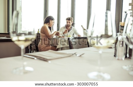 romantic lunch in a fancy restaurant.couple sitting and eating at lunch time
