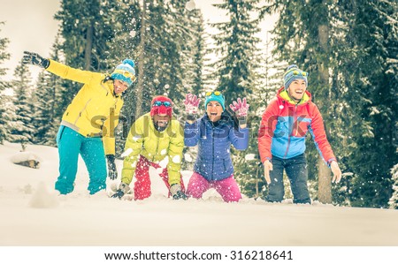group of friends playing on the snow. concept about winter, fun and people. group of people in a row spraying snow around.