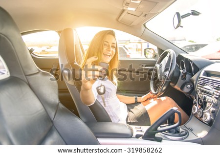 woman showing the keys inside a sport car. sexy business woman ready to drive. concept about transportation