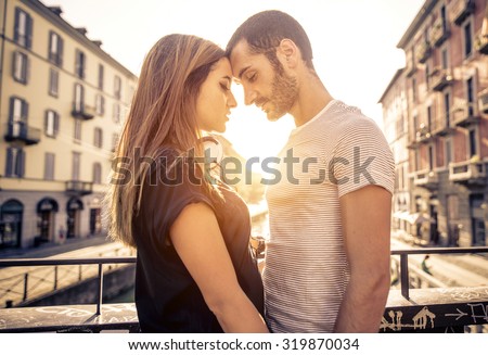 couple kissing each other on a bridge over the river. concept about passion and love