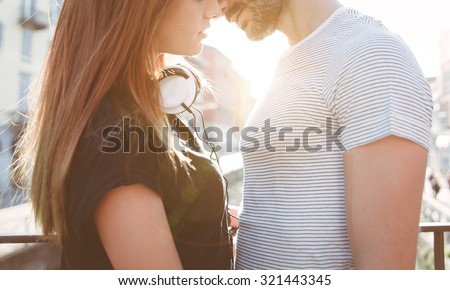 young couple kissing on a bridge in Milan.concept about love and romance. boy kissing his girlfriend