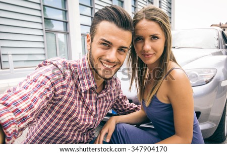 Successful couple portrait. Business man with beautiful wife,sport car and modern house