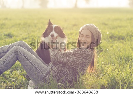 Young woman playing with her border collie dog. concept about animals and people