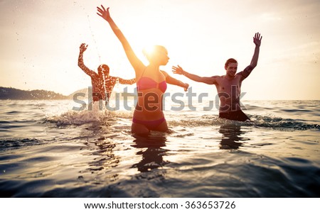 Group of friends jumping and make party in the water. Celebrating summer in a tropical place. Phuket, thailand