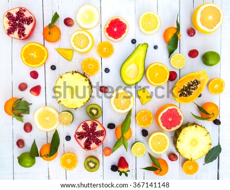 Mix of colored fruits on white wooden background  - Composition of tropical and mediterranean fruits - Concepts about decoration, healthy eating and food background