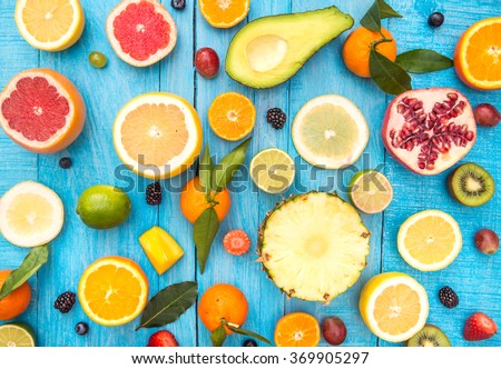 Mix of colored fruits on white wooden background - Composition of tropical and mediterranean fruits - Concepts about decoration, healthy eating and food background