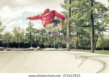 Young man making skateboarding outdoor in a skate park. Having fun and making extreme sport