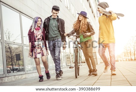 Group of teens walking in an urban area. Concept about friendship and youth