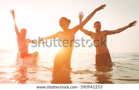 Group of friends jumping and make party in the water. Celebrating summer in a tropical place. Phuket, thailand