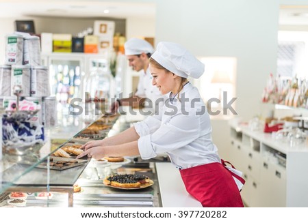 Pastry chefs working in a bar cafeteria