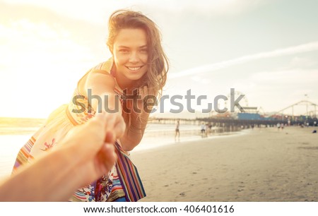 Girlfriend inviting his boyfriend to the beach in Santa monica, los angeles