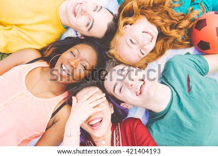 Group of four friends laughing out loud outdoor, sharing good and positive mood.