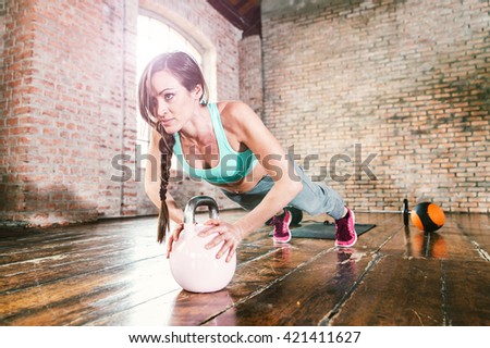 Woman training hard with push up exercise in her gym