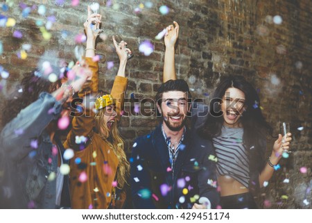 Group of four friends laughing out loud outdoor, sharing good and positive mood. Making party outdoor with champagne and confetti