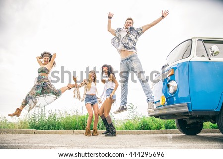 Multi-ethnic group of friends having fun on a summer road trip - Young happy people driving in the nature, drinking and dancing