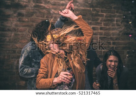 Group of young adults hanging around in a disco club