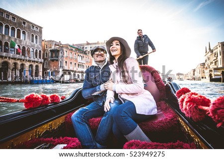 Couple of lovers on vacation in Venice, Italy - Tourists having a trip on a venetian gondola