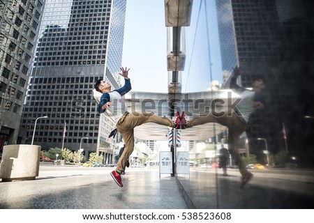 Parkour man doing tricks on the street - Free runner training his acrobatic port outdoors