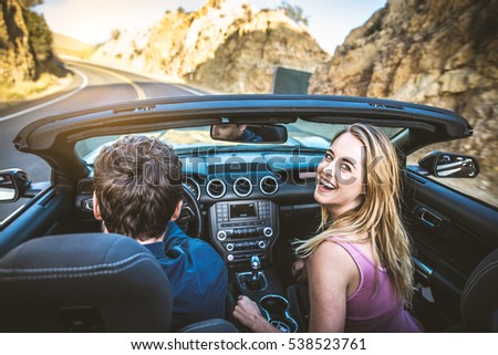 Couple of lovers driving on a convertible car - Newlywed pair on a romantic date