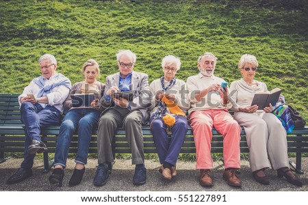 Group of senior people resting in a park - Mature friends doing some activities in a retirement home