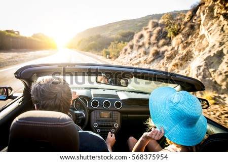 Couple of lovers driving on a convertible car - Newlywed pair on a romantic date