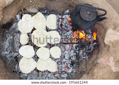 Cooking churasca on a fire and boiling water