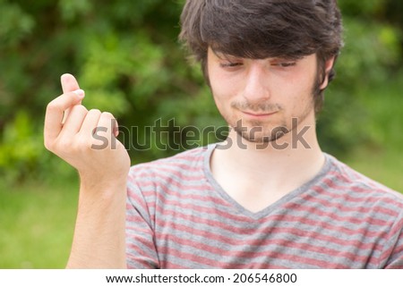 A young male student snaps with his fingers