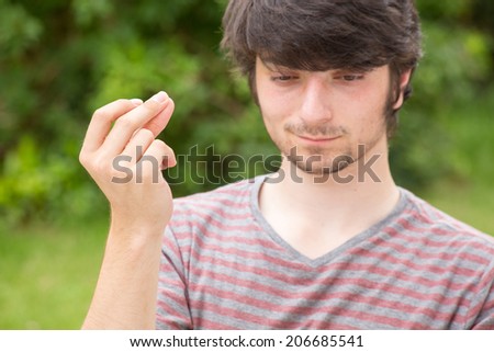A young male student snaps with his fingers