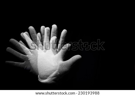 Hand is posing with white gloves on a black background. Multiflash used.