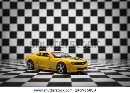 Chevrolet Camaro toy car product shot on checkered background. Chevrolet is a automobile manufacturer at USA. Owner is General Motors Company. Shoot date and location: Turkey - Izmir. January 14 2015