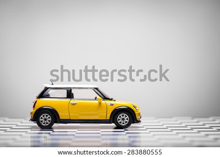 Izmir, Turkey - June 01, 2015.  Mini Cooper S Toy car on white background and checked floor.