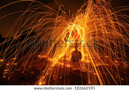 Burning steel wool firework during night