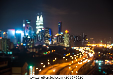 Blurred lights of Kuala Lumpur skyline, love shape bokeh