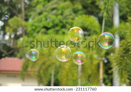 Blur image of children playing with giant bubble